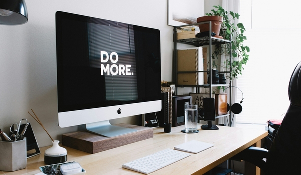 image of a computer at a desk saying DO MORE on the background