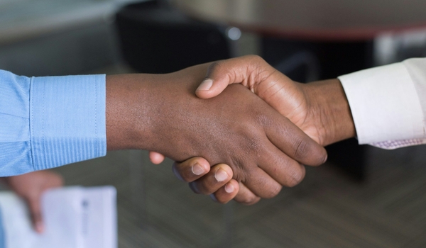 two hands shaking to show happy brand advocates